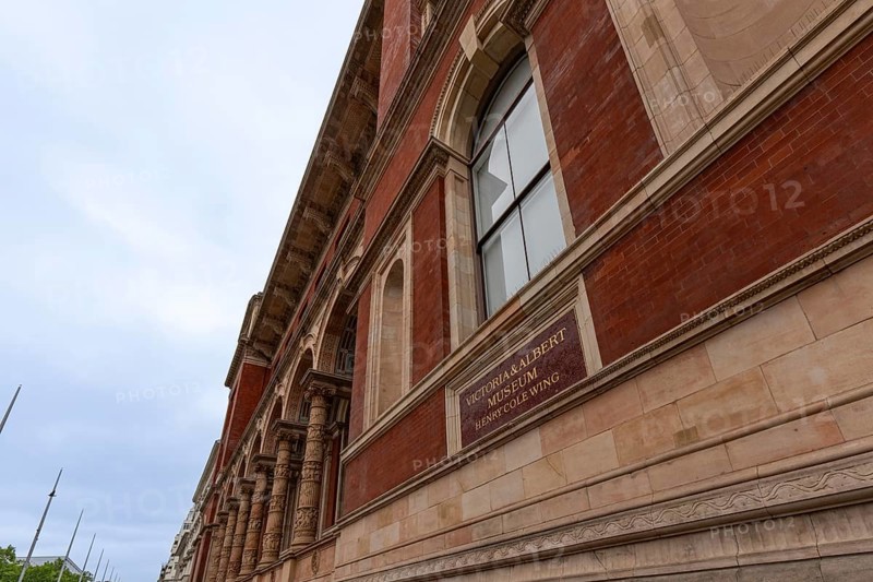 London, United Kingdom - 15 May 2025: Historic stone facade and red brick walls of the renowned London Victoria and Albert Museum