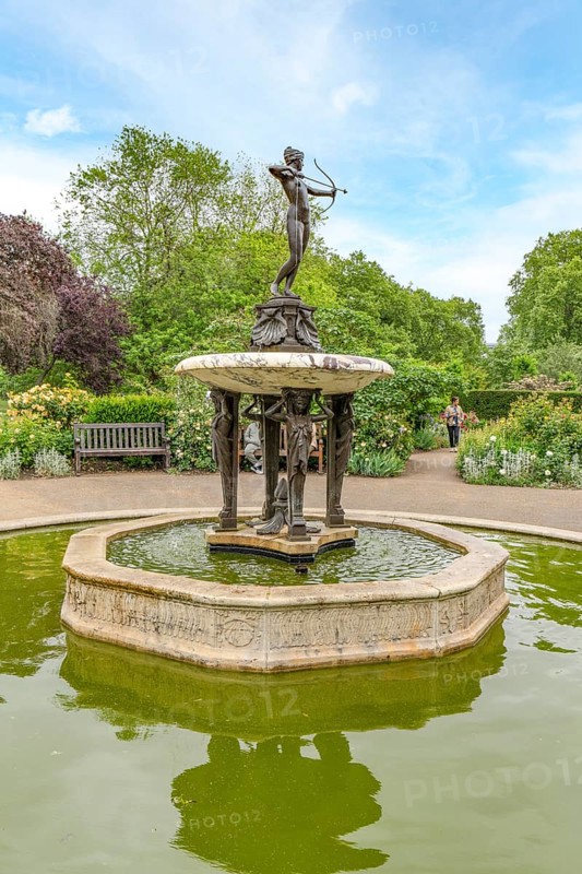 London, United Kingdom - 15 May 2025: Charming bronze Diana the Huntress fountain surrounded by lush rose gardens in Hyde Park