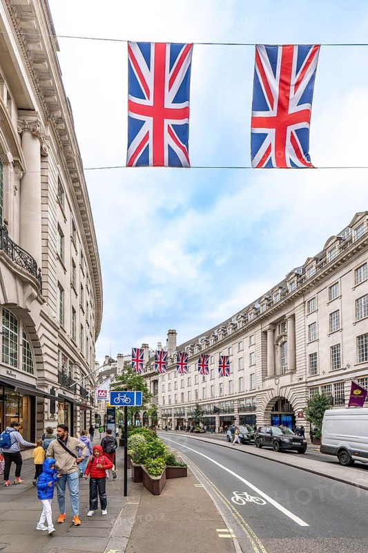 London, United Kingdom - 15 May 2025: Iconic Regent Street: sweeping curve of neoclassical buildings adorned with union jack flags