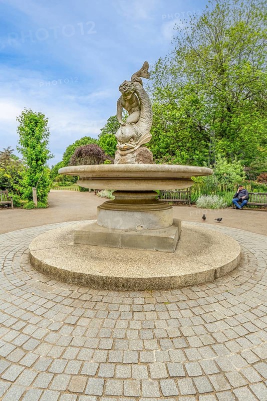 London, United Kingdom - 15 May 2025: Classic stone sculpture of a sea creature in the tranquil Rose Garden of Hyde Park