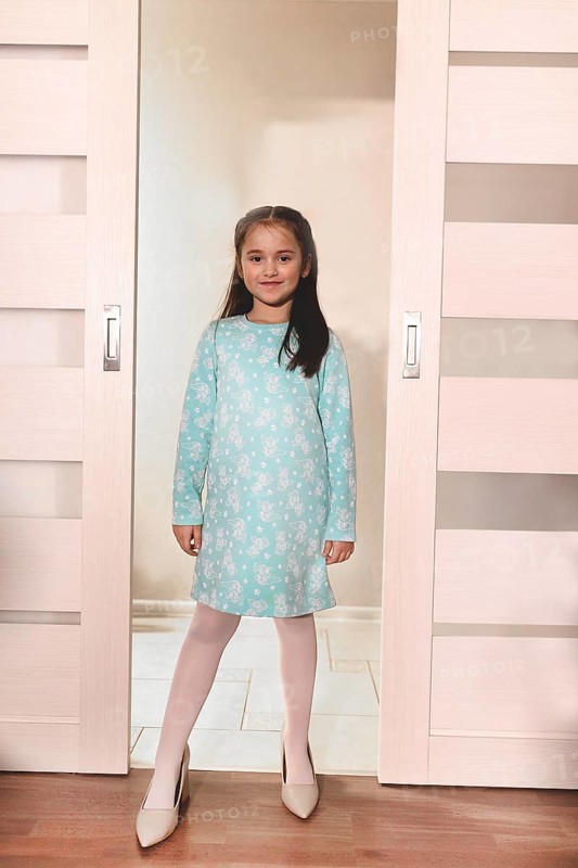 Young girl standing in a doorway wearing high heels, imagining growing up.Belarus