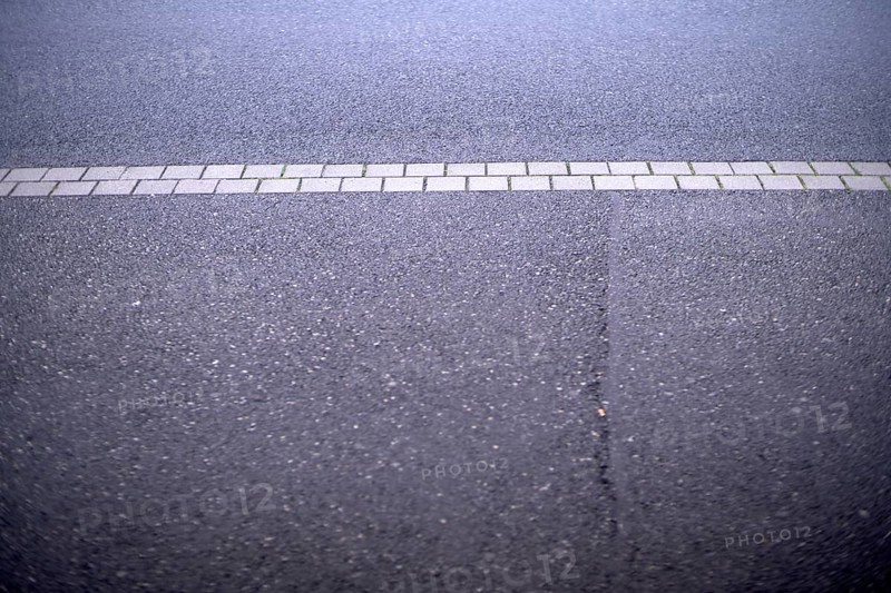 Weather conditions caused a crack in the street asphalt requiring public maintainance financed by taxpayer money to fix it and empower the public interest and economic sector that requires functional street infrastructures, Germany