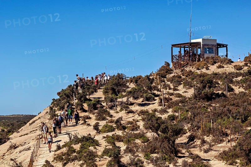 Hiker on a hill trail with views and an observation point in the blue sky, The countryside of Peninsula Valdes in Argentina