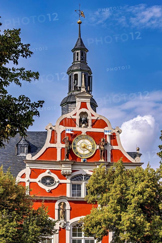 Magnificent baroque building with clock and decorative bell tower against a blue sky, the old town of Arnstadt in Thuringia