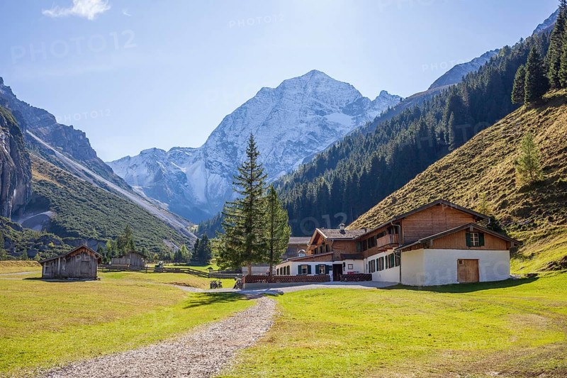 Snowy mountain hawk with alpine inn Pinnisalm in autumn, Pinnistal, Neustift im Stubai Valley, Stubai Valley, Tyrol, Austria