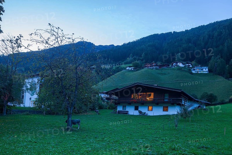 Houses, meadow and mountains with holiday home at dusk, Neustift im Stubai Valley, Stubai Valley, Stubai, Tyrol, Austria