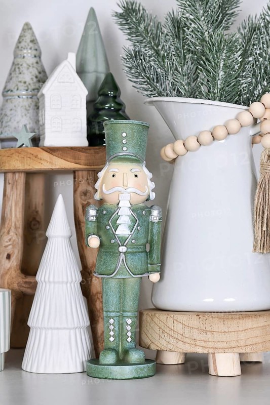 Beautiful farmhouse or boho style Christmas home decoration with trendy mint green nutcracker
