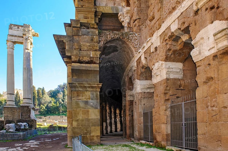 Center and right part of preserved façade of historic ancient Marcellus Theatre, left ruin of ancient columns from the Temple of Apollo, Rome, Lazio, ItalyRome, Lazio, Italy