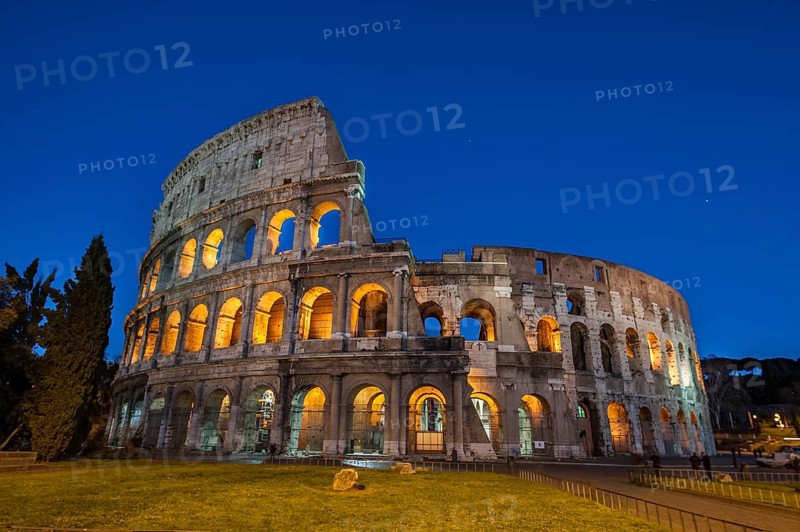 Night view photo in Blue Hour of Amphiteatrum Flavium Colosseum Colosseo in ancient center of Rome, Parco Archeologico del Colosseo, Archaeological Park at the Colosseum, Rome, Lazio, Italy