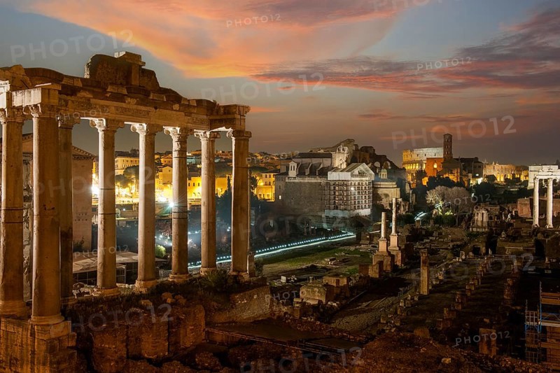 Night view photo at dusk evening view of Roman Forum, left column ruin remains of Temple of Saturn, Rome, Lazio, Italy