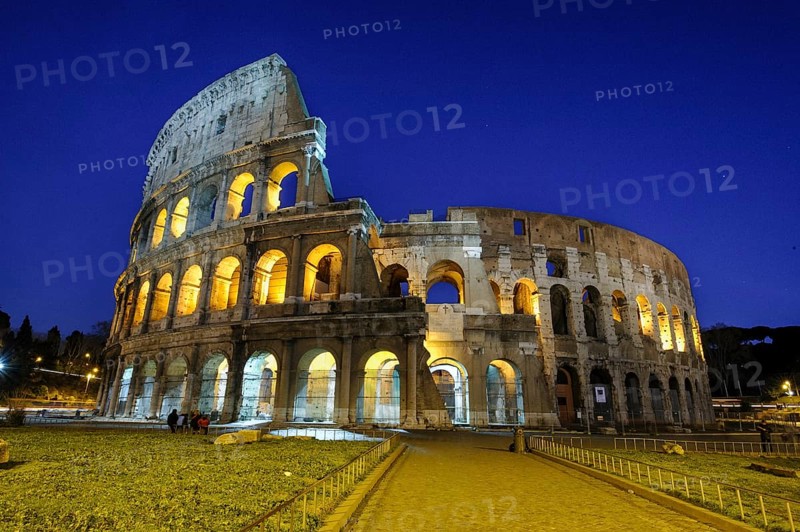 Night view photo in blue hour of historic arena Amphiteatrum Flavium Colosseum Colosseo in ancient center of Rome, Parco Archeologico del Colosseo, Archaeological Park at the Colosseum, Rome, Lazio, Italy