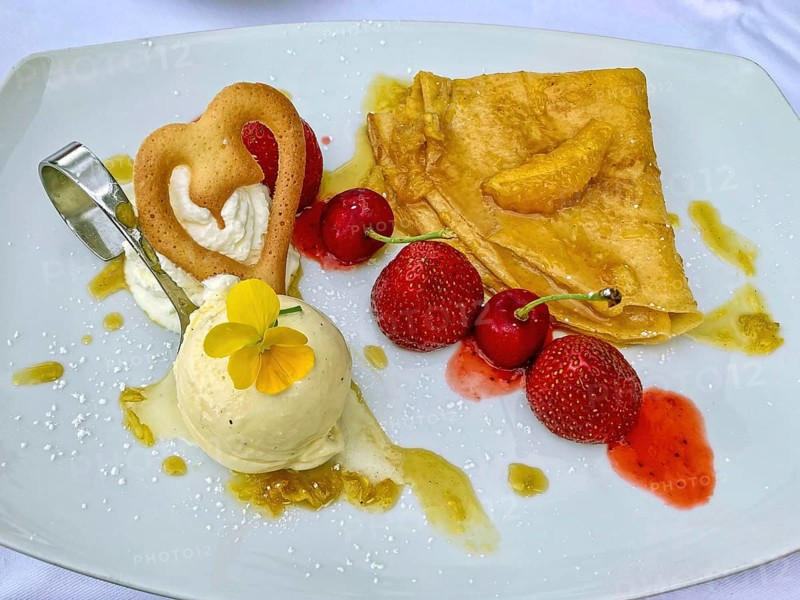 Calorie dessert dessert cream with a scoop of vanilla ice cream fruits strawberries cherries, international