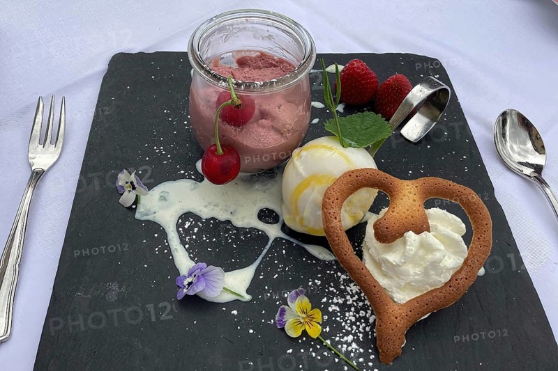 Dessert sweet dish cherry mousse with vanilla ice cream and heart-shaped pastry, international