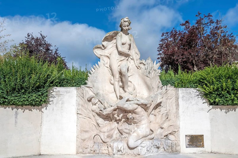 The light stone fountain sculpture La Naissance de Venus (The Birth of Venus) by sculptor Henri Greber depicts the mythological figure of Venus standing on a sea animal or a shell and is surrounded by green spaces in Beauvais, Oise department (60), Hauts-de-France region, France