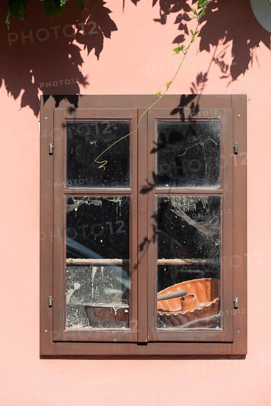 Pink house facade, window with old objects, Kranj, Upper Carniola, Slovenia