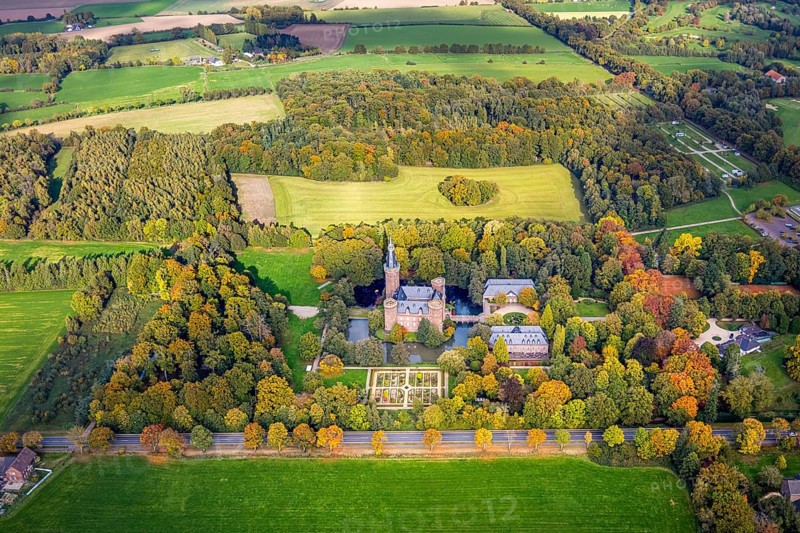 Aerial view, Moyland Castle Museum, neo-Gothic moated castle and castle park with herb garden surrounded by meadows and fields and autumn forest, tourist destination on the Lower Rhine, Moyland, Bedburg-Hau, Lower Rhine, North Rhine-Westphalia, Germany