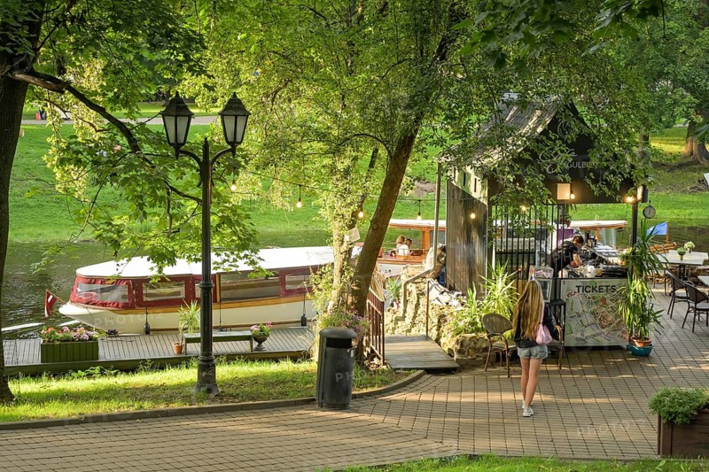 People, leisure, sightseeing boat, city canal, municipal park, Riga, Latvia
