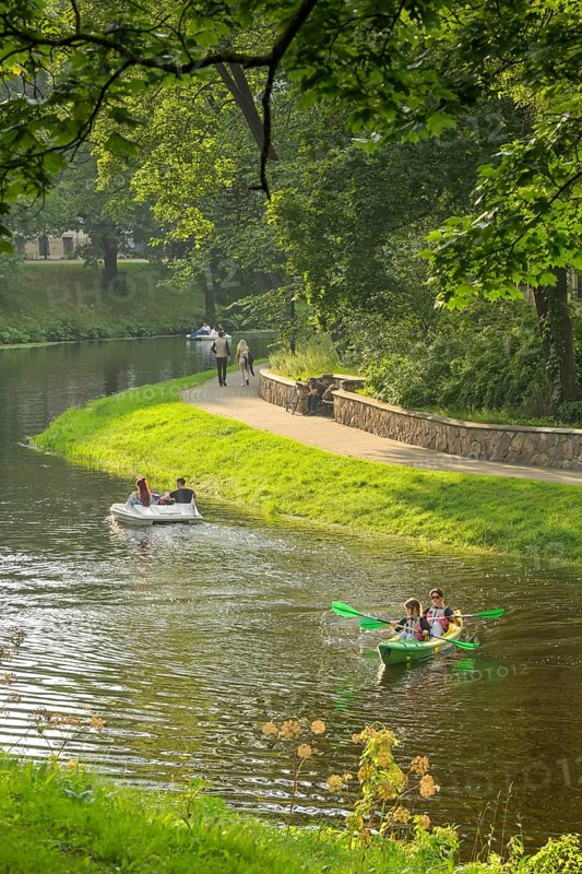 People, leisure, paddle boat, kayak, city canal, municipal park, Riga, Latvia