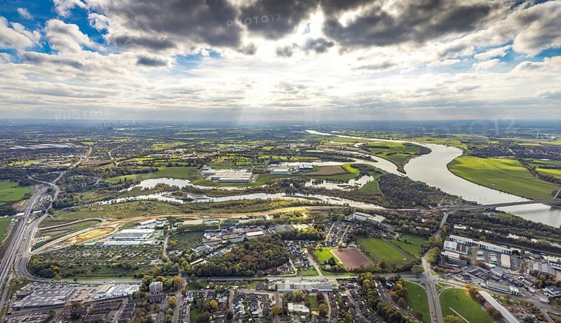 Aerial view, Lippe estuary with construction site, Lippe river and NSG nature reserve, Büdericher Insel, Rhine-Lippe harbour with Rhenus Logistics and Nordfrost GmbH, on the left the federal road B8 bridge at Lippeschlösschen in front the Am Lippeglacis industrial estate, blue sky with clouds, Wesel, Lower Rhine, North Rhine-Westphalia, Germany, Am Lippeglacis, construction, construction site, development, bridge, federal road B8, business, DE, Europe, river Lippe, riverbank, building, commercial area, port, trade, industry, infrastructure, landscape, Lippe estuary, Lippeschlösschen logistics, aerial photography, aerial photography, NSG, nature, nature reserve, Nordfrost GmbH, town view, perspective, Rhine-Lippe-Hafen, Rhenus Logistics, Ruhr area, protected area, urban planning, transport, overview, urban, traffic, traffic connection, bird's eye view, waterway, residential area, birds-eyes view, overview