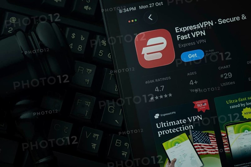 Dhaka, Bangladesh- 28 Oct 2025: An iPad displaying the ExpressVPN app against a judge's gavel and dark keyboard background