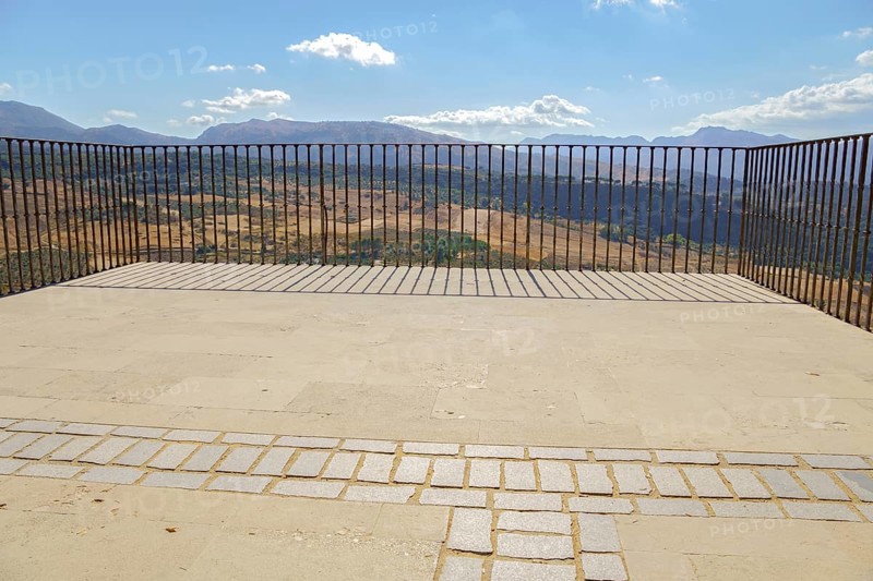 Ronda, malaga, spain Empty outdoor viewpoint balcony offering panoramic summer views of ronda's dry landscape and distant mountains on a sunny day