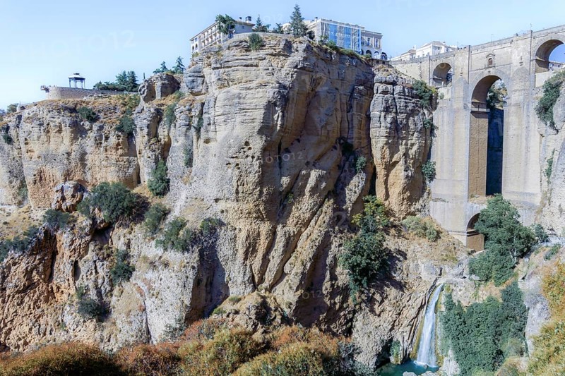 Ronda, malaga, spain Puente nuevo bridge connecting the old and new towns of ronda, spain, with a waterfall flowing into el tajo gorge