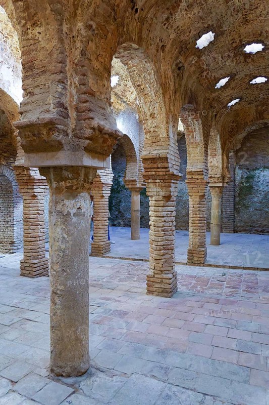 Ronda, malaga, spain Ancient moorish architecture with brickwork arches, columns, and star-shaped openings in the historic arab baths