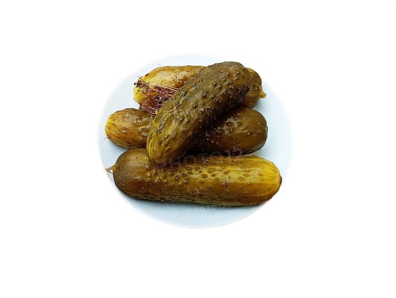 A plate of salted and crispy cucumbers and a sprig of dill