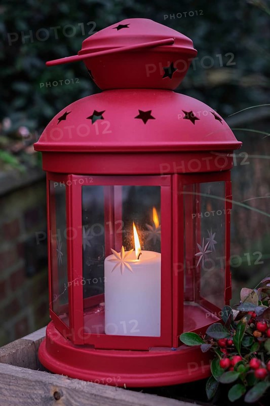 Red lantern with burning candle surrounded by a festive atmosphere, North Rhine-Westphalia, Germany
