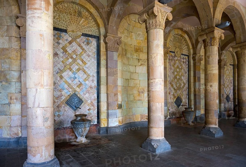 Column with mosaic walls and reliefs surrounded by stone arches that create an ancient atmosphere, Mineral Water Gallery in Jermuk, Jermuk, mineral springs, health resort, Vayots Dzor province, Armenia