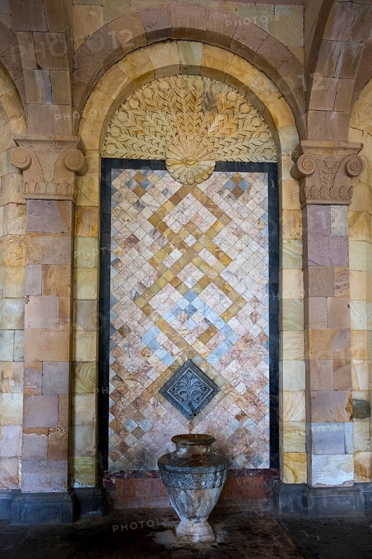 Detailed mosaic with decorative patterns and reliefs on the wall above a stone jug, spring, mineral water gallery in Jermuk, mineral spring, health resort, Wajoz Dzor province, Vayots Dzor, Armenia