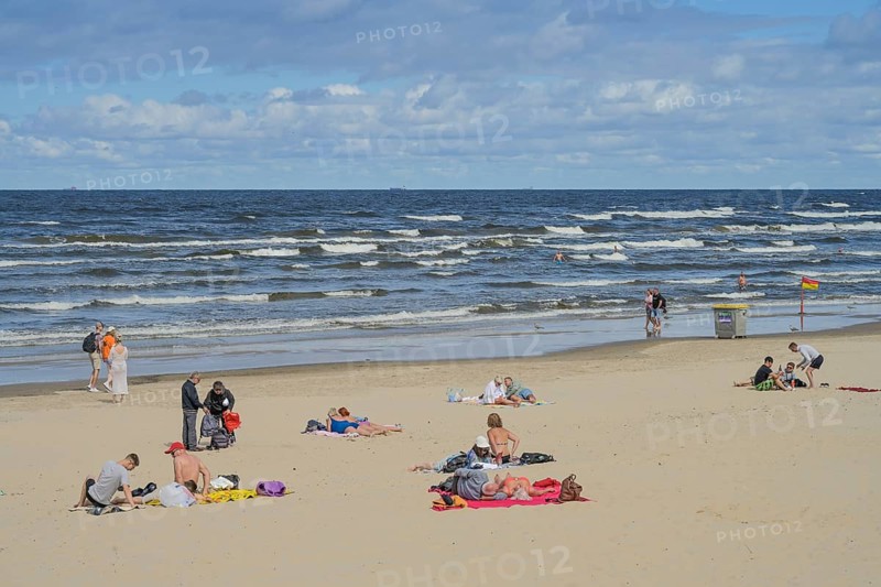 People on sandy beach, Baltic Sea, waves, Jurmala, Latvia