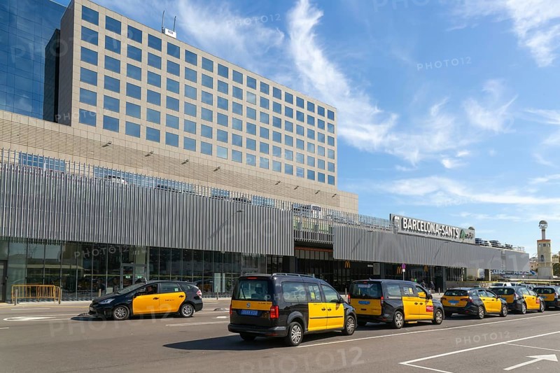 Taxis in street outside Barcelona-Sants railway station building in city centre, Barcelona, Catalonia, Spain