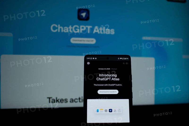 A smartphone showing ChatGPT Atlas with a bright blue background