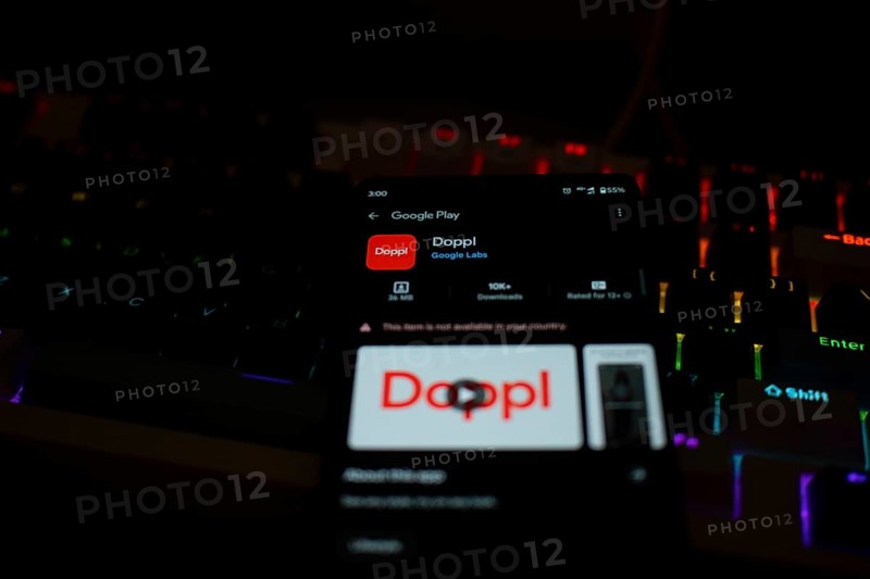 Smartphone displaying Doppl app on Google Play in front of a lit keyboard