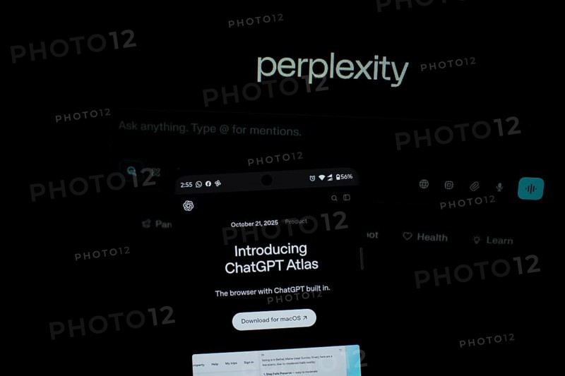 Smartphone screen with ChatGPT Atlas text against a background labeled perplexity