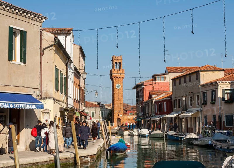 Clock tower and canal on island Murano, Venice, Italy