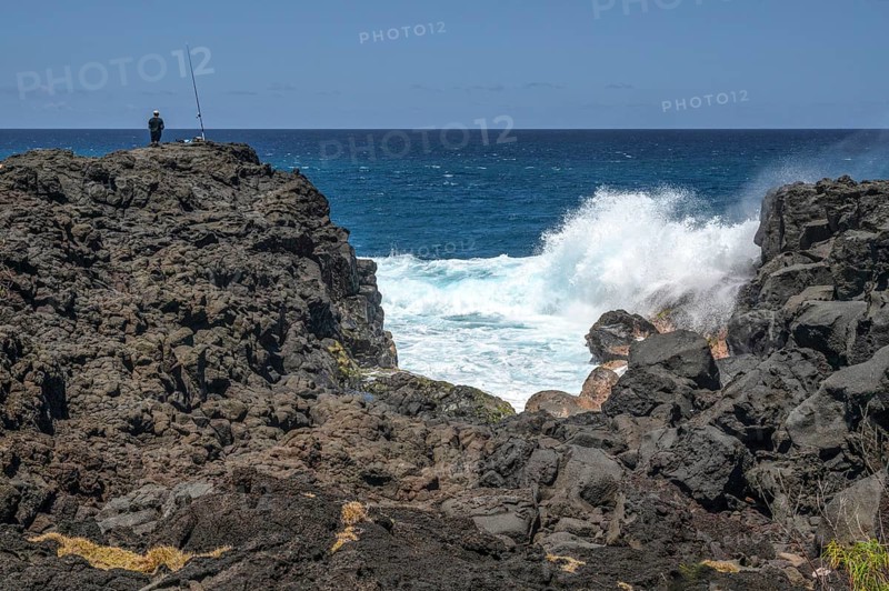 Thundering surf washes around the black lava cliffs of the south coast of the Indian Ocean, very close to the Marine de Vincendo car park, south coast, La Reunion, France