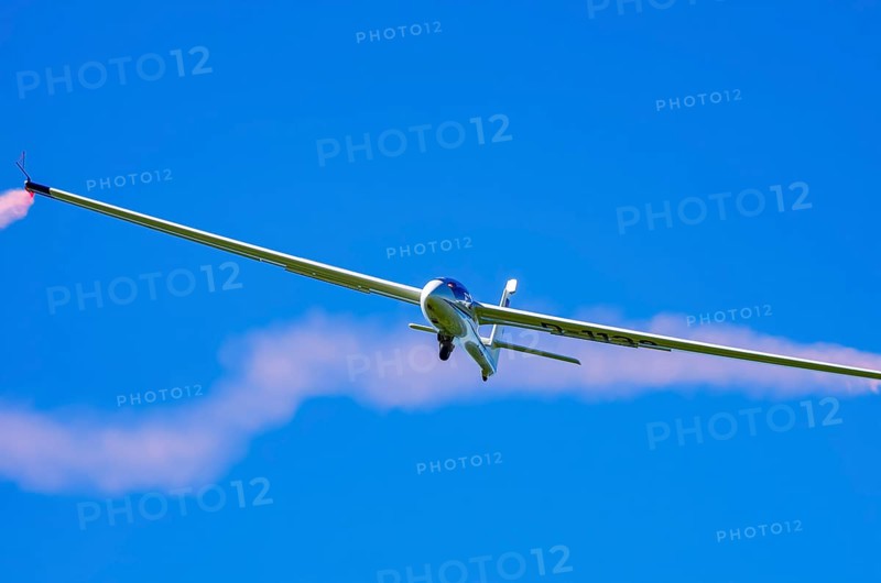 An SZD-59-1 ACRO glider, registration D-1138, during a demonstration as part of an air show at the Fliegerbergfest of the Rossfeld Luftsportverein in Metzingen-Glems, Baden-Württemberg, Germany, for editorial use only