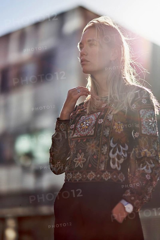 Elegant designer woman in sunlight in front of futuristic modern architecture house, apartment buildings, future oriented, pondering about future, making plans, calmly feeling sensation, fashion design, architecture student, fashion design student, design student, relaxed, backlit, lens flare, sensitive, steadfast, curious, mindset, trends, youth, modernity, architectural design, designer, pensive, thinking, pondering, ideas, wistful remeniscing, beauty, attractive, fashion model, blond, dutch ethnicity