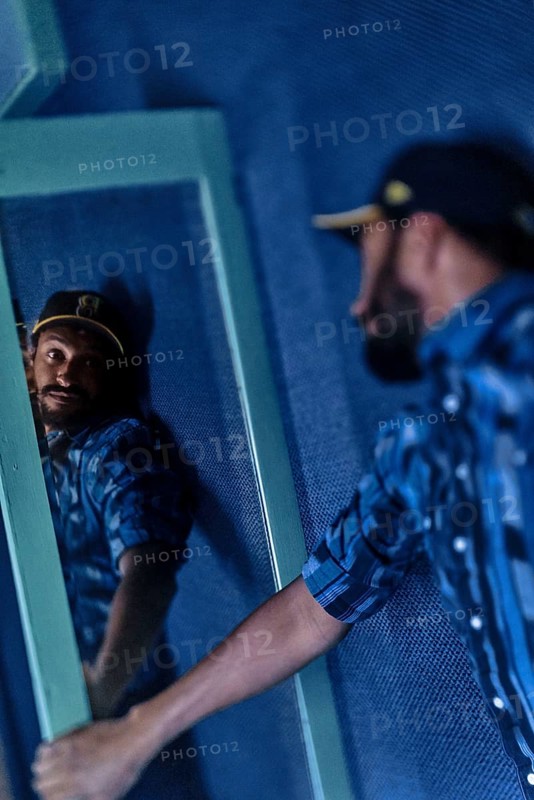 EDITORIAL and NEWS ONLY, celebrity and stand-up comedian Matt Okine looking at himself in mirror backstage with introspective self-perception a few minutes before his stage gig performance in Adelaide, Australia