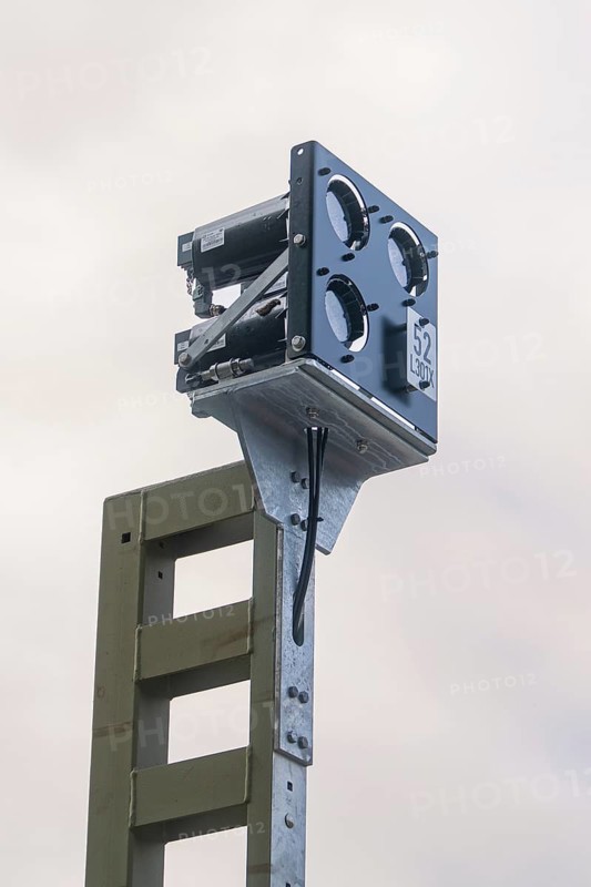 Camera on a pole, taken against grey cloudy sky, signalling at the Hermann Hessebahn, Calw, Germany