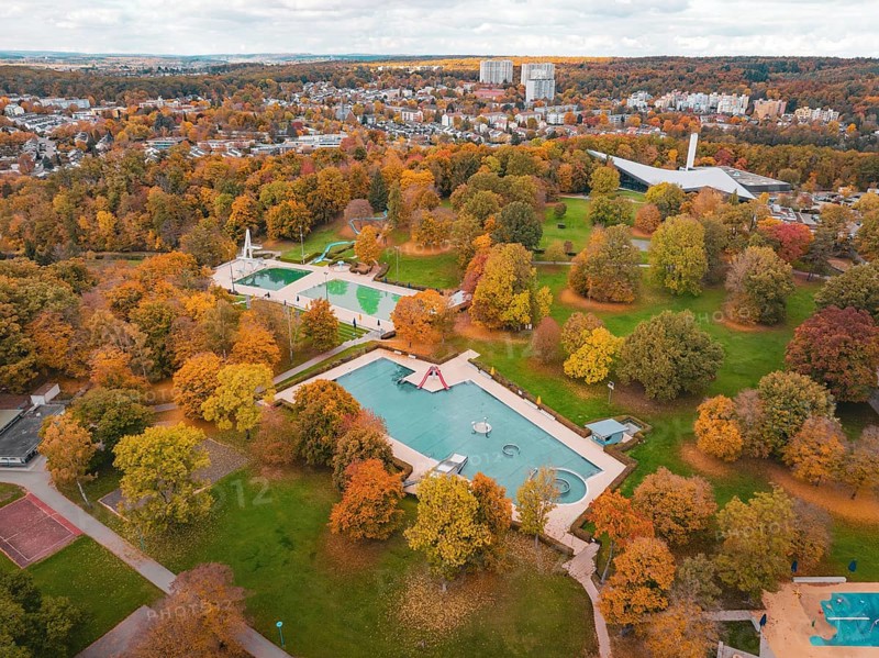 A swimming pool surrounded by autumn trees, nestled in a large park, Sindelfingen, Böblingen district, Germany