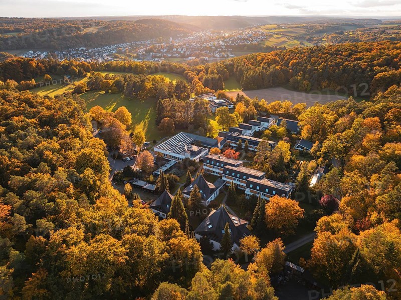 Motherhouse building in autumn landscape with sunset and village in background, Aidlingen, Böblingen district, Germany