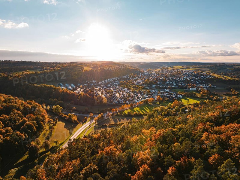 Colourful autumn landscape with a view of a village and vast forests under the evening sun, Aidlingen, Böblingen district, Germany