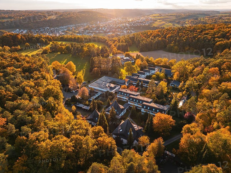 Motherhouse buildings and autumn trees in rural area at sunset, Aidlingen, Böblingen district, Germany