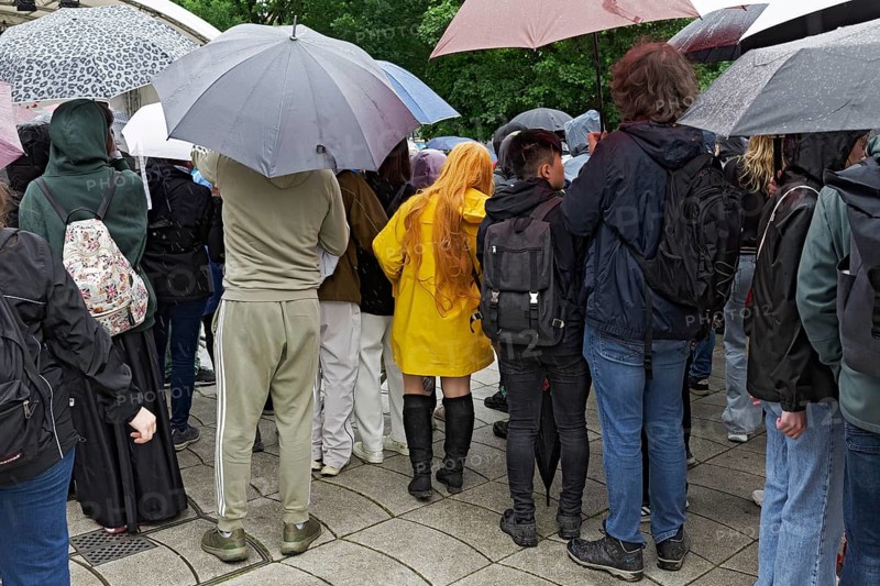 Young spectators with umbrellas in back view, woman with bright yellow rain jacket in between, Japan Day Düsseldorf, North Rhine-Westphalia, Germany