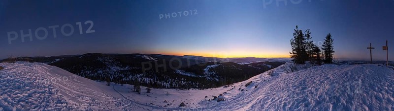View from Mount Lusen over the hills of the bavarian forest at sunrise in winter, Bavaria, Germany