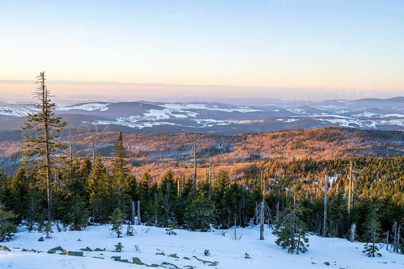 View from Mount Lusen over the hills of the bavarian forest at sunrise in winter, Bavaria, Germany