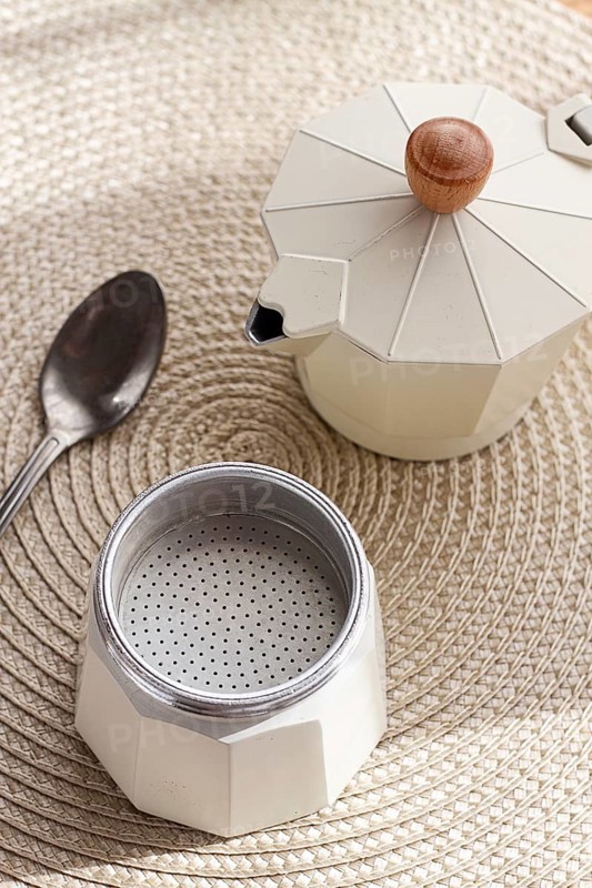 Geyser coffee maker, empty and clean, disassembled on the table, coffee preparation, sunlight, breakfast